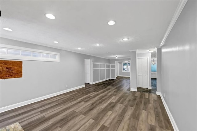 basement featuring dark wood-type flooring and crown molding