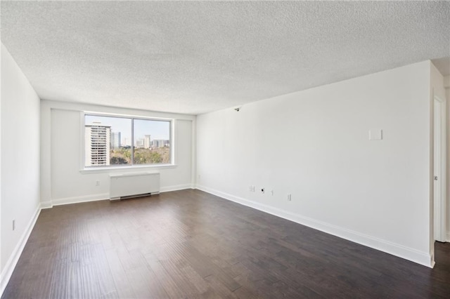 2479 Peachtree Rd NE Unit 1703, Atlanta, GA 30305 - unfurnished room featuring radiator, dark wood finished floors, and a textured ceiling