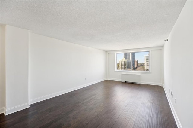 2479 Peachtree Rd NE Unit 1703, Atlanta, GA 30305 - unfurnished room with radiator heating unit, a textured ceiling, and dark wood-style flooring
