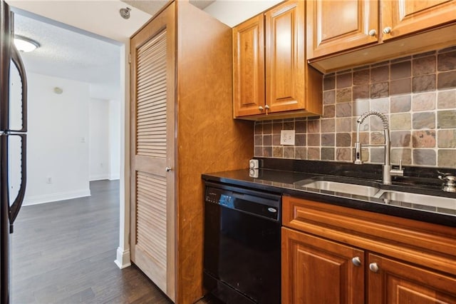 2479 Peachtree Rd NE Unit 1703, Atlanta, GA 30305 - kitchen featuring dishwasher, decorative backsplash, dark wood-style flooring, brown cabinets, and refrigerator