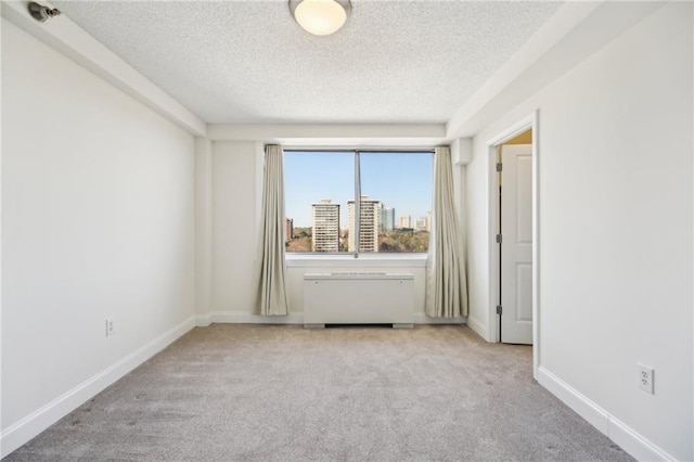 2479 Peachtree Rd NE Unit 1703, Atlanta, GA 30305 - spare room with a textured ceiling, carpet floors, and radiator heating unit