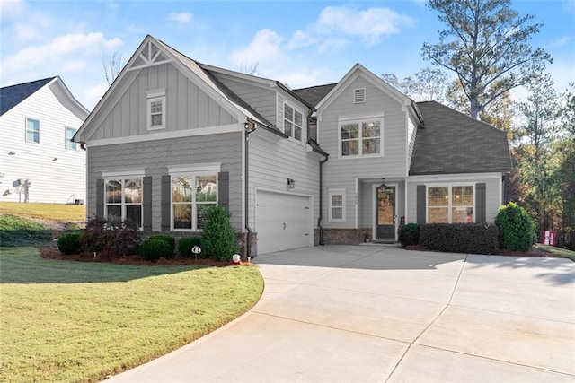 view of front facade featuring board and batten siding, a garage, driveway, and a front lawn