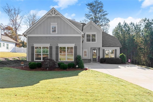 craftsman inspired home with board and batten siding and a front lawn