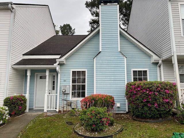 view of front facade with a chimney