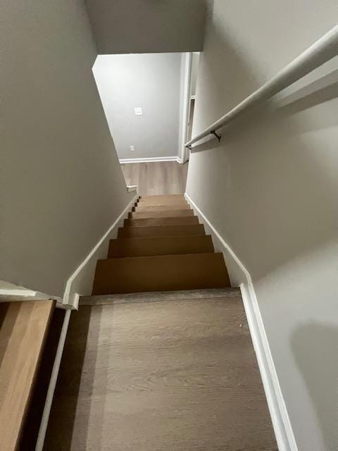 stairs with wood finished floors