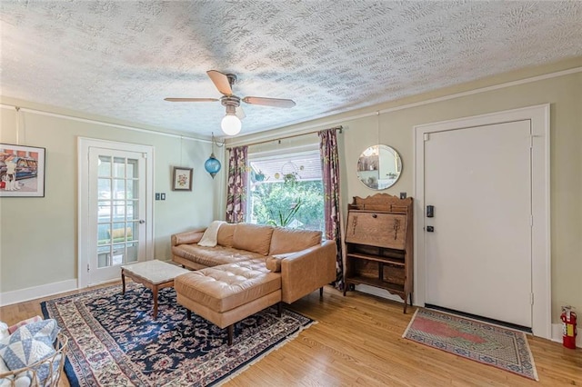 2669 Jefferson Ter, East Point, GA 30344 - living room featuring crown molding, ceiling fan, light wood-style floors, and a textured ceiling