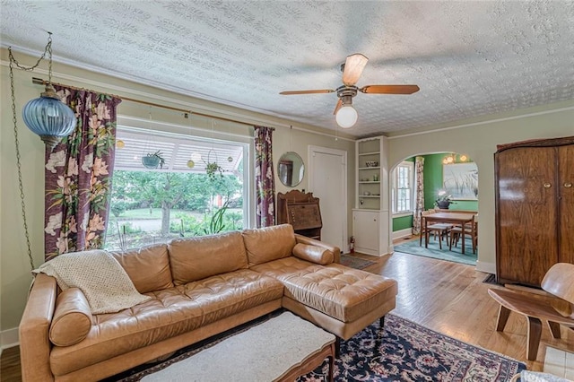 2669 Jefferson Ter, East Point, GA 30344 - living area with arched walkways, crown molding, wood finished floors, ceiling fan, and a textured ceiling