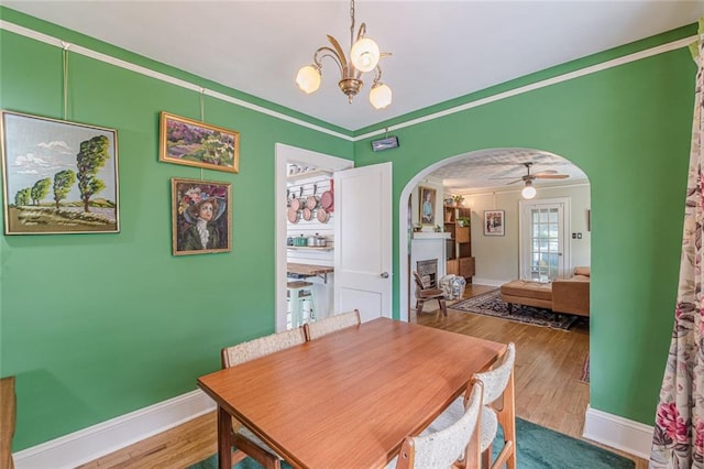 2669 Jefferson Ter, East Point, GA 30344 - dining space with arched walkways, wood finished floors, a chandelier, baseboards, and ornamental molding