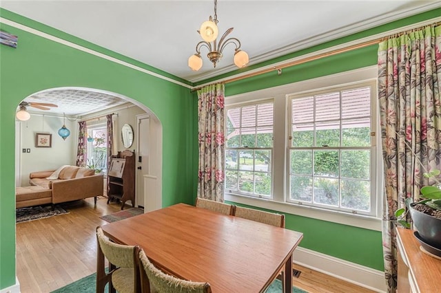 2669 Jefferson Ter, East Point, GA 30344 - dining space featuring arched walkways, wood finished floors, a chandelier, crown molding, and ceiling fan