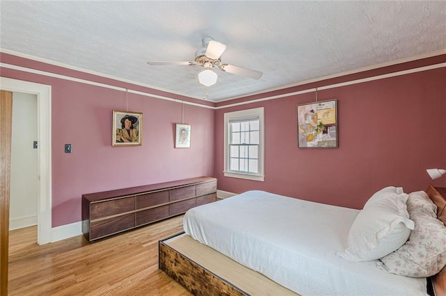 2669 Jefferson Ter, East Point, GA 30344 - bedroom featuring wood finished floors, a textured ceiling, baseboards, crown molding, and a ceiling fan