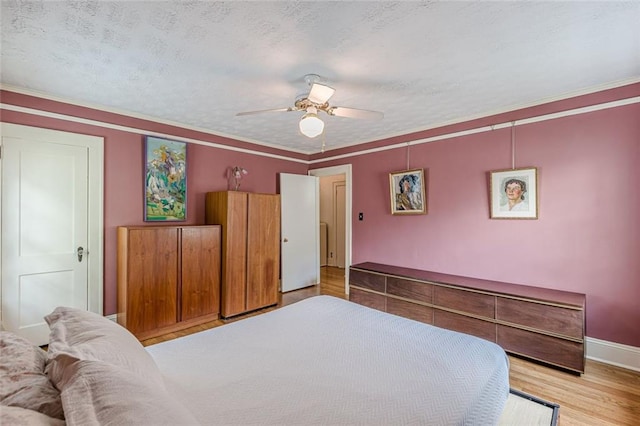 2669 Jefferson Ter, East Point, GA 30344 - bedroom with wood finished floors, baseboards, ceiling fan, a textured ceiling, and crown molding
