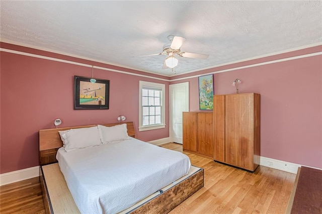 2669 Jefferson Ter, East Point, GA 30344 - bedroom with baseboards, light wood-style flooring, a textured ceiling, ceiling fan, and ornamental molding