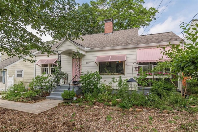 2669 Jefferson Ter, East Point, GA 30344 - view of front facade featuring a chimney and roof with shingles