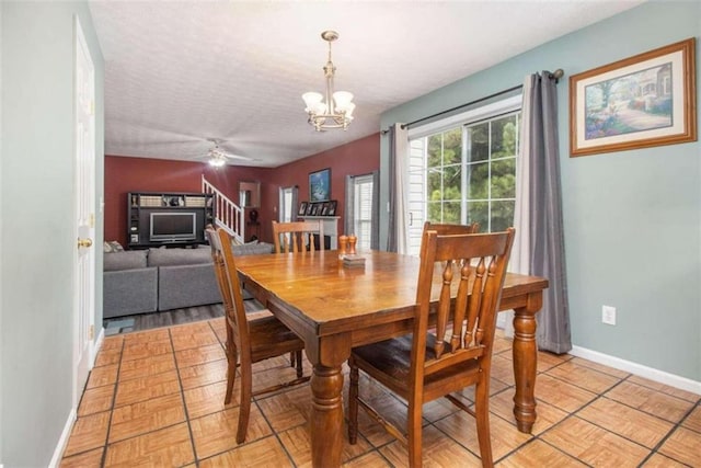 dining area with ceiling fan with notable chandelier