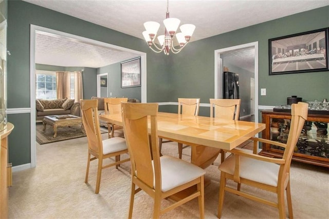 dining space with light colored carpet and a chandelier