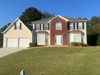 view of front of house with a garage and a front lawn