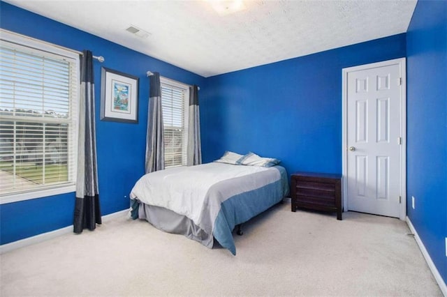 carpeted bedroom with a textured ceiling