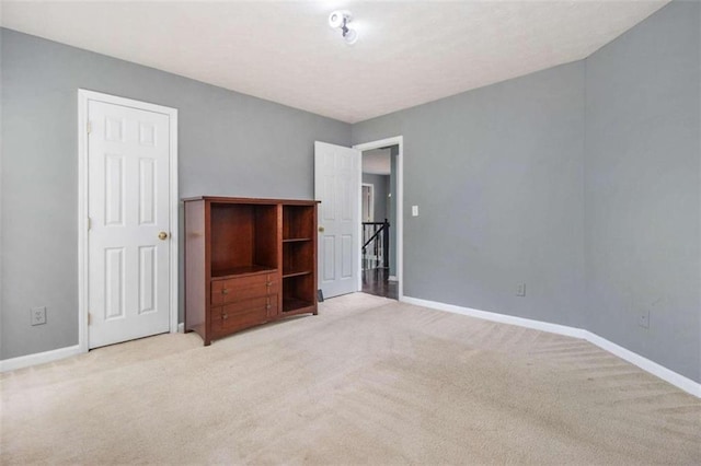 unfurnished bedroom featuring light colored carpet