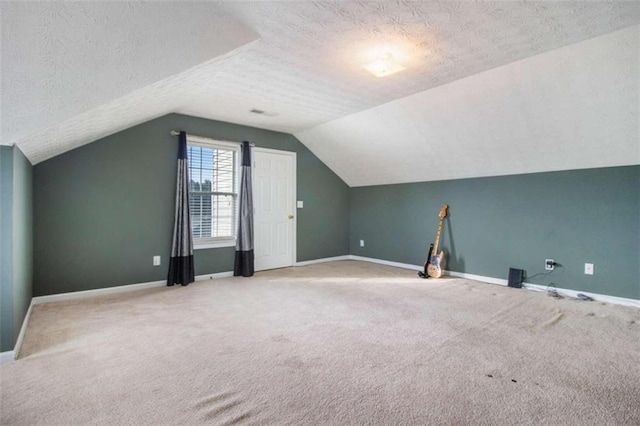 bonus room featuring carpet flooring, a textured ceiling, and vaulted ceiling