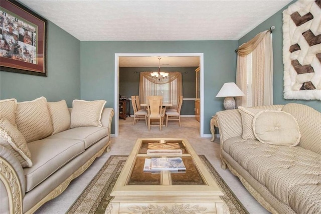 carpeted living room with a notable chandelier and a textured ceiling