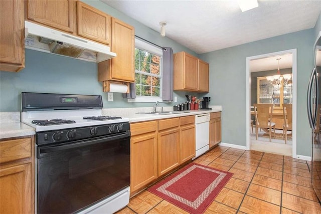 kitchen with a notable chandelier, sink, and white appliances