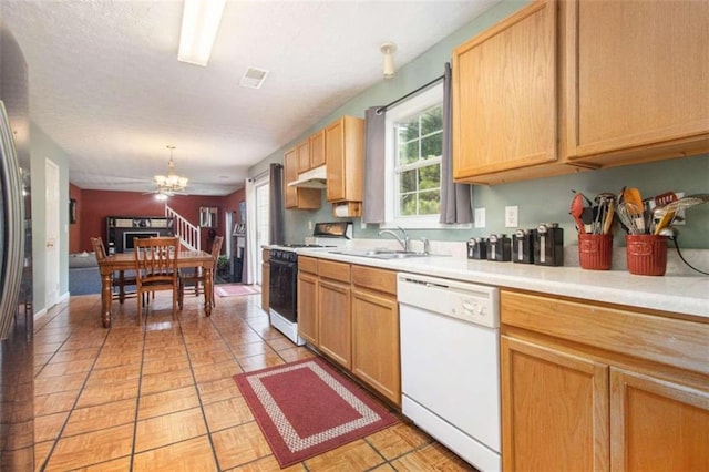 kitchen featuring pendant lighting, sink, an inviting chandelier, white appliances, and light tile patterned floors