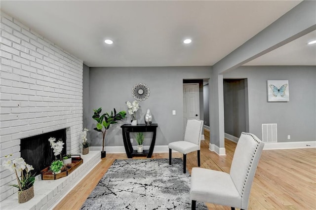 sitting room featuring hardwood / wood-style flooring and a fireplace