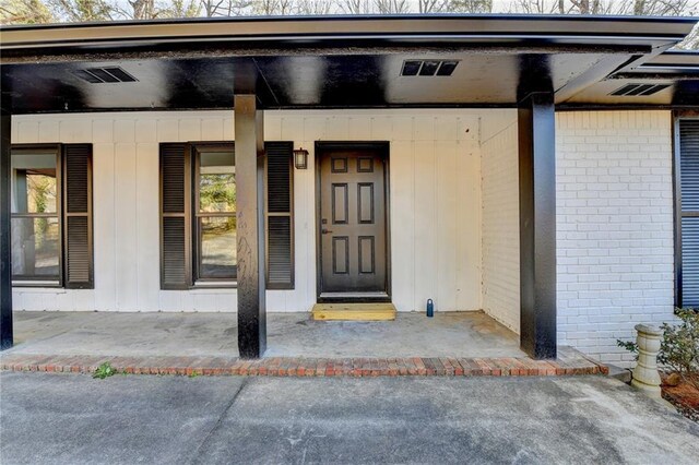 view of exterior entry with covered porch