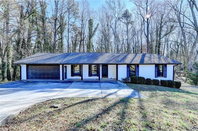 single story home featuring a front yard and a garage