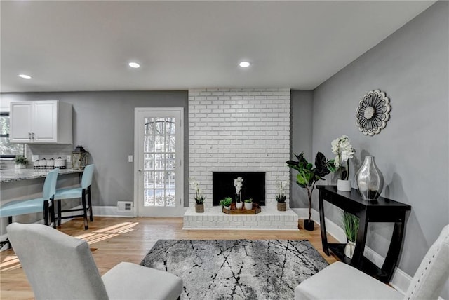 living room featuring light hardwood / wood-style floors and a fireplace