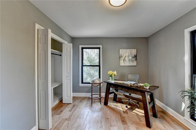 office area with light hardwood / wood-style floors