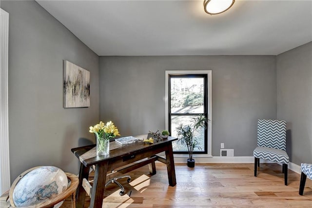 office area with light hardwood / wood-style flooring