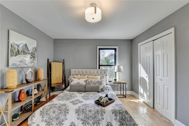 bedroom with light wood-type flooring and a closet