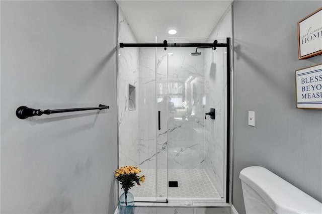 bathroom featuring toilet and walk in shower