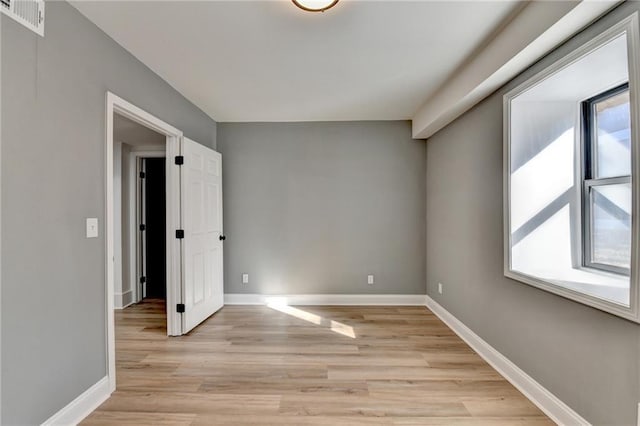 spare room featuring light hardwood / wood-style floors