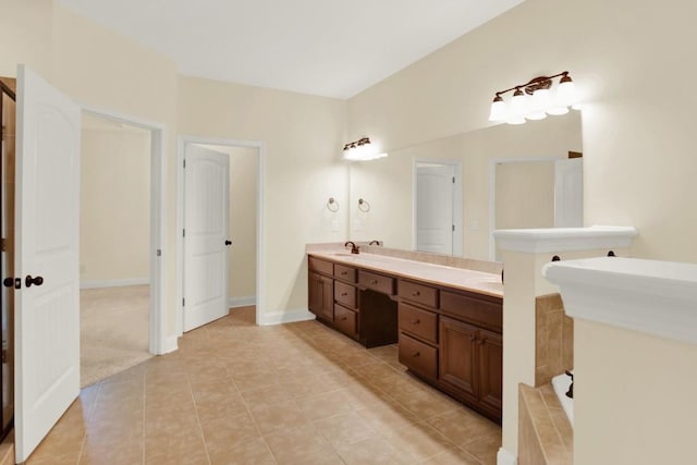 bathroom featuring vanity, a tub, and tile patterned floors