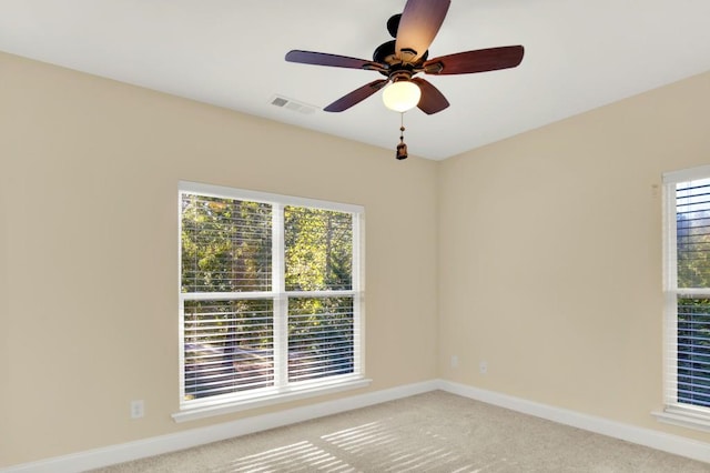 unfurnished room featuring carpet floors, a healthy amount of sunlight, and ceiling fan