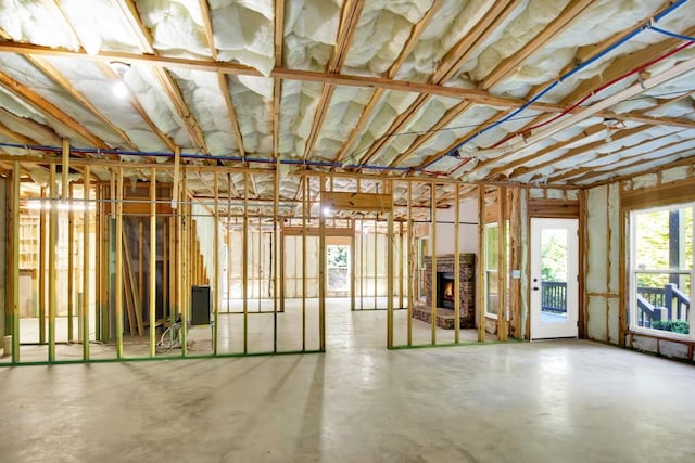 miscellaneous room with concrete flooring and a fireplace