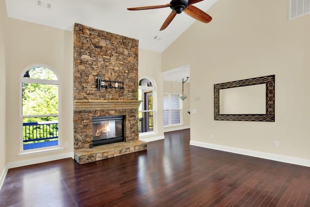 unfurnished living room with high vaulted ceiling, dark wood-type flooring, a fireplace, and ceiling fan