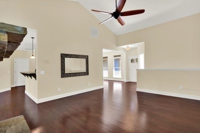 unfurnished living room with dark wood-type flooring, high vaulted ceiling, and ceiling fan