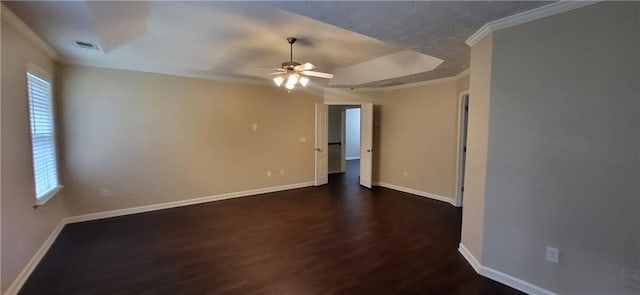 571 Cold Water Ln, Mcdonough, GA 30252 - empty room with dark wood finished floors, ornamental molding, ceiling fan, and a tray ceiling