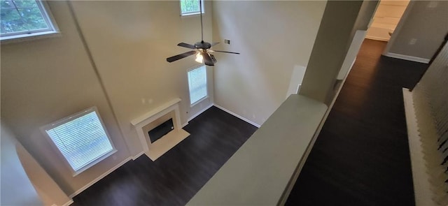 571 Cold Water Ln, Mcdonough, GA 30252 - unfurnished living room with dark wood-style floors, plenty of natural light, and a fireplace with flush hearth