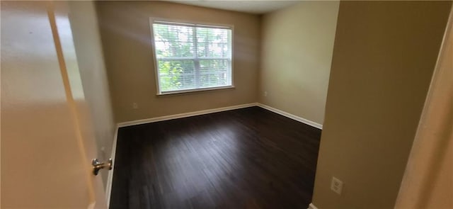 571 Cold Water Ln, Mcdonough, GA 30252 - unfurnished room featuring baseboards and dark wood-style flooring