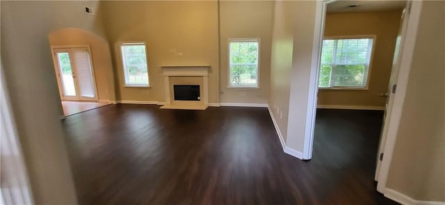 571 Cold Water Ln, Mcdonough, GA 30252 - unfurnished living room with dark wood-style flooring and a fireplace with raised hearth