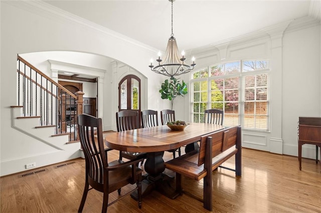 office featuring coffered ceiling, french doors, arched walkways, beam ceiling, and wood finished floors
