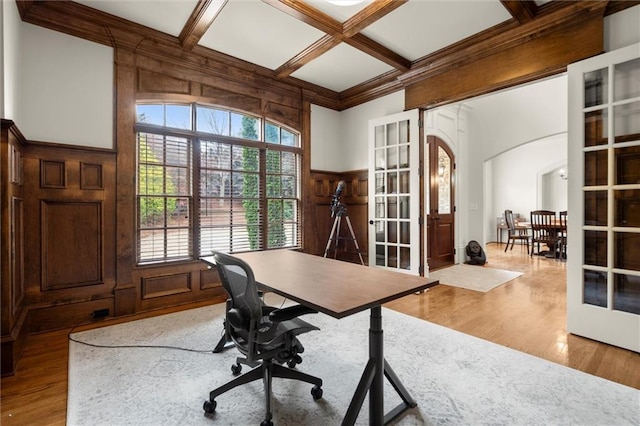 home office with built in shelves, wood finished floors, coffered ceiling, and beam ceiling
