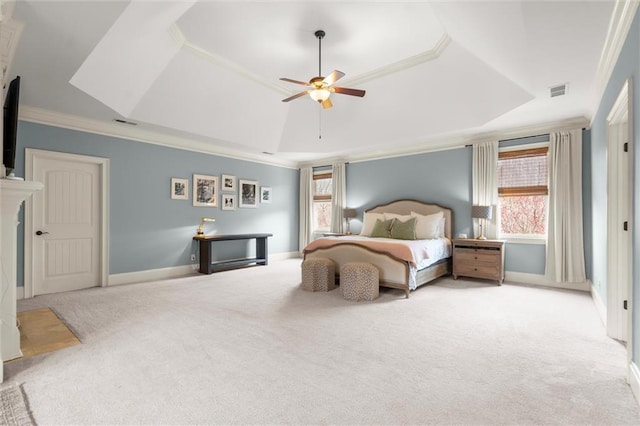 bedroom with visible vents, crown molding, carpet, baseboards, and a tray ceiling