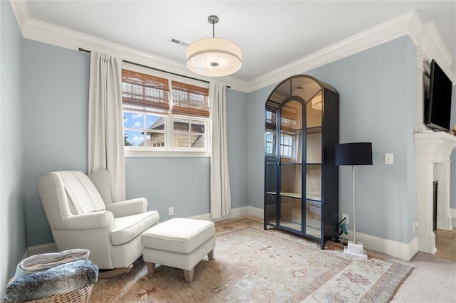 sitting room with baseboards, visible vents, arched walkways, and ornamental molding