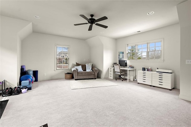 office space featuring light colored carpet, ceiling fan, and baseboards