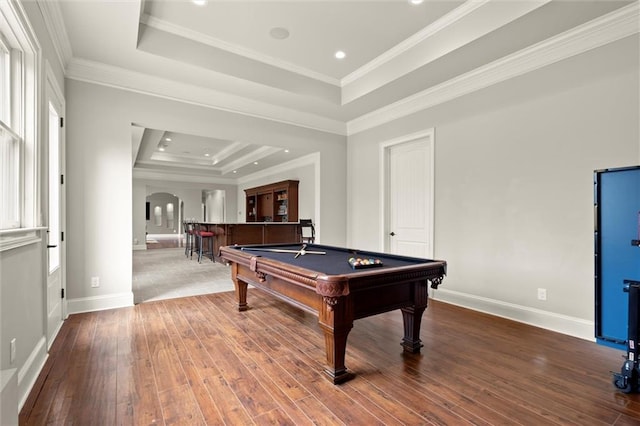 playroom with a tray ceiling, crown molding, pool table, arched walkways, and hardwood / wood-style floors